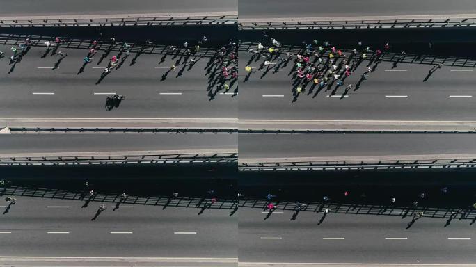 4k空中无人机搁脚。马拉松在街上跑。一群运动员。顶视图