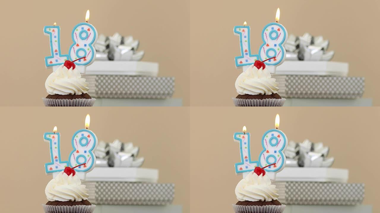 纸杯蛋糕粉彩背景中的18支蜡烛