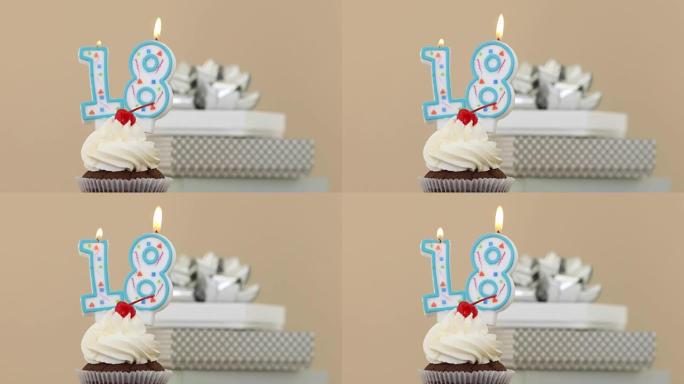 纸杯蛋糕粉彩背景中的18支蜡烛