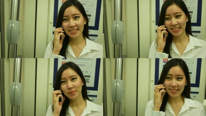 在城市火车上使用智能手机的年轻女商人