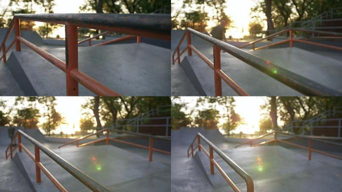 日落时在混凝土滑板公园里玩花样的滑板手的剪影，慢动作