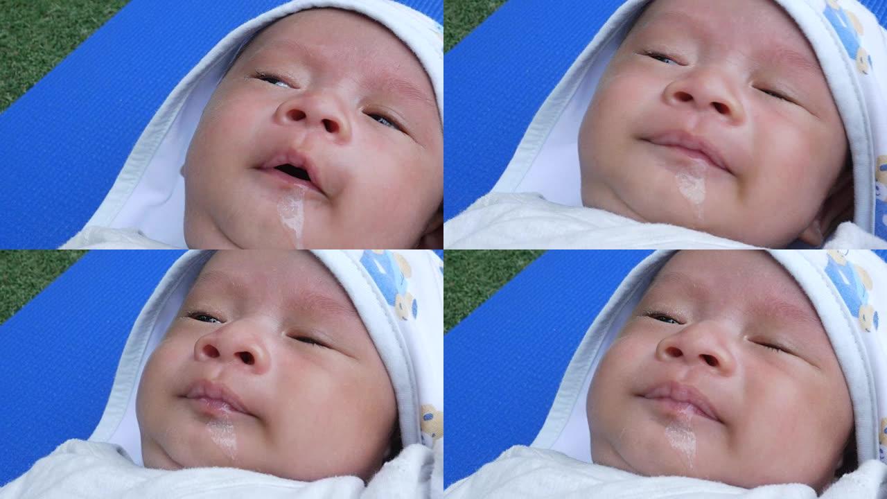 新生儿、呕吐牛奶的面部表情