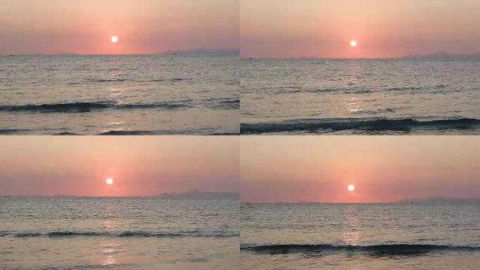 海滩戏剧性美丽的日落令人敬畏的太阳金色反射平静的海浪表面背景。