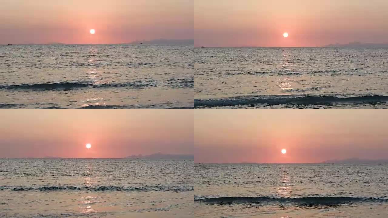 海滩戏剧性美丽的日落令人敬畏的太阳金色反射平静的海浪表面背景。
