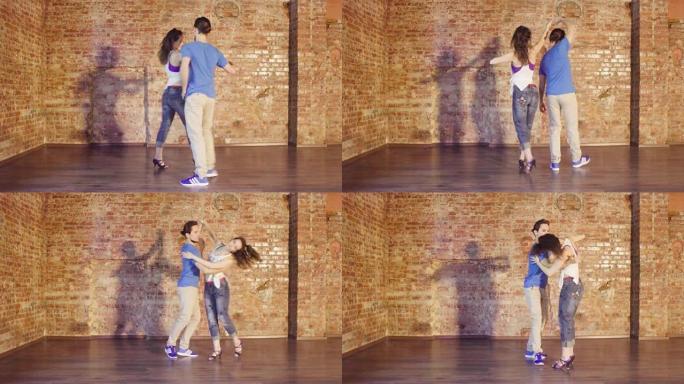 夫妇在大厅里用旧砖墙跳舞