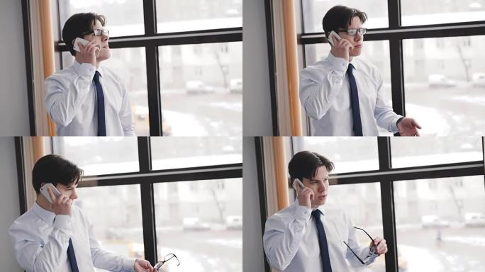 Handsome man speaking on the phone in office at wi