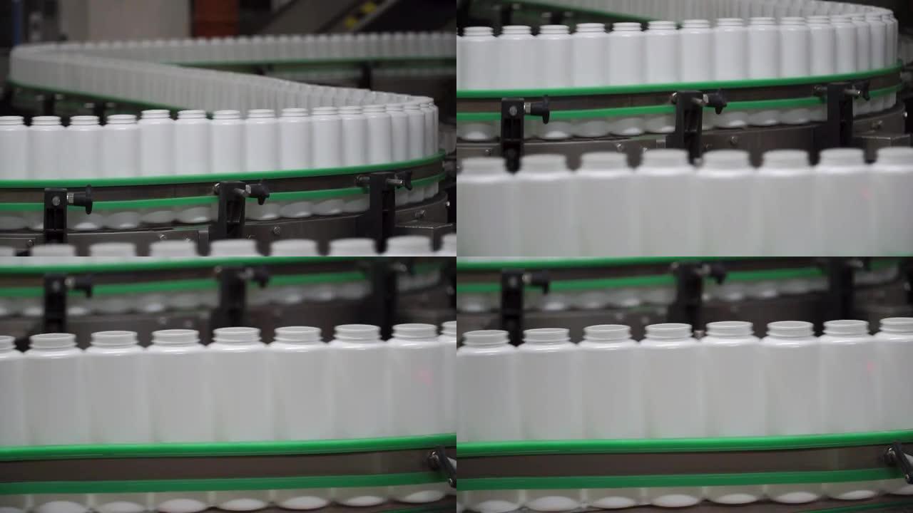 工厂和研究概念。夹。瓶子在生产线上移动。传送带上的瓶子。生产流程