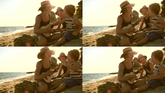 母亲在海滩上和男孩们弹吉他