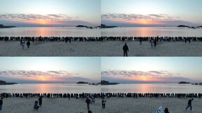 航拍威海半月湾看日出的人群