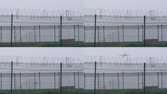 透过机场围栏拍摄一架飞机起飞飞出画面4K