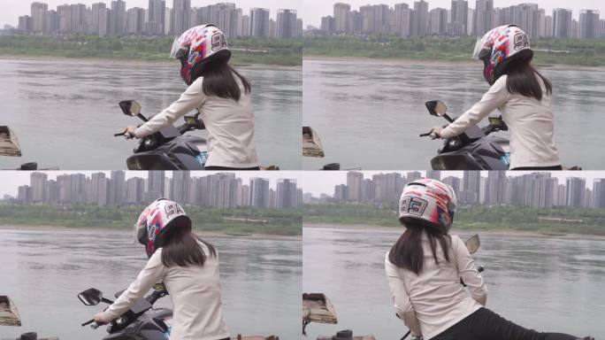 一名女骑手骑机车来到江边