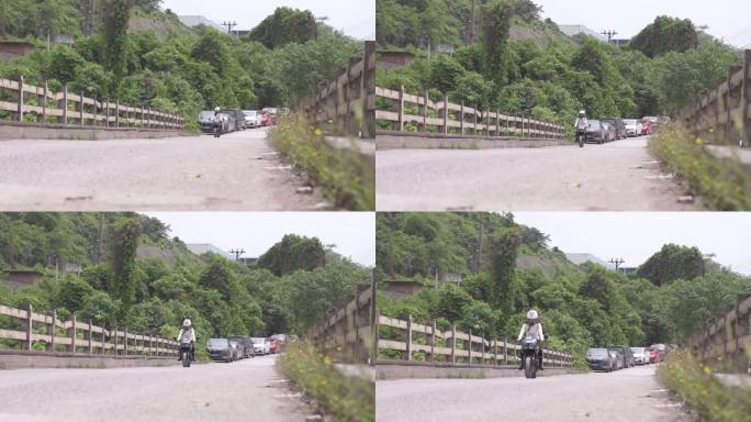 一名女子骑着一辆小摩托过桥