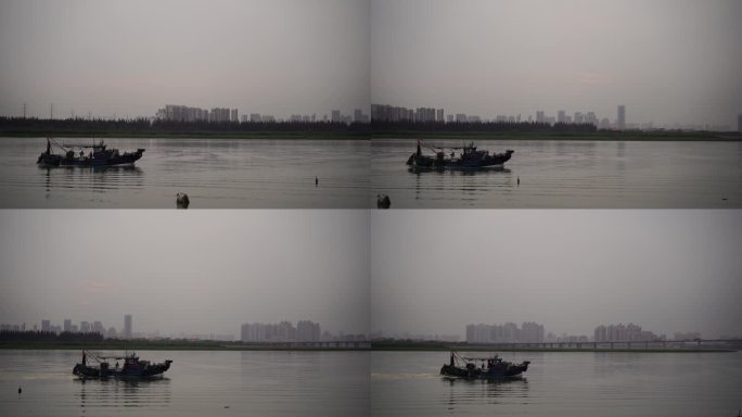 阴天傍晚长江上的渔船捕鱼船只行驶