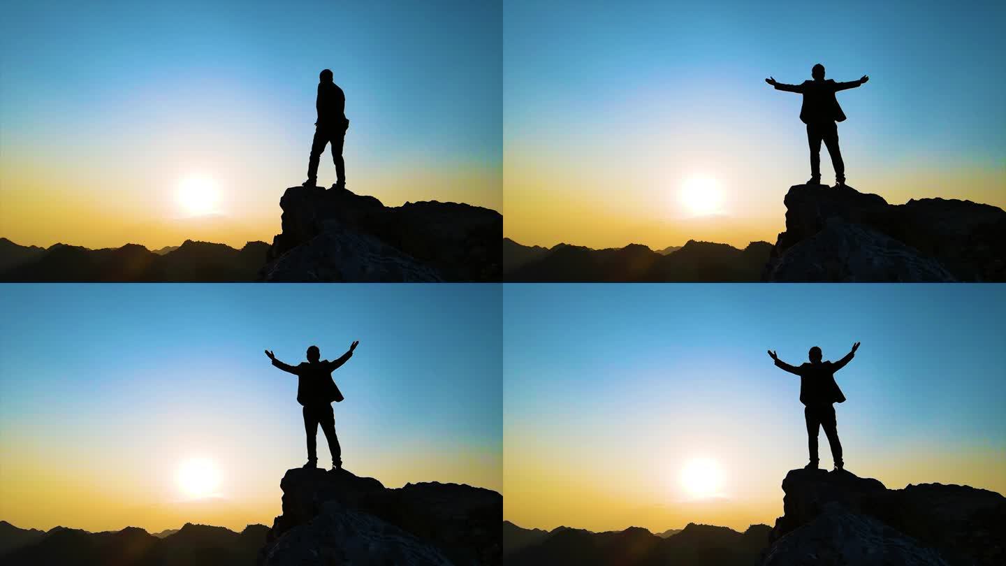 张开双臂拥抱未来山顶人物剪影西装男人背影