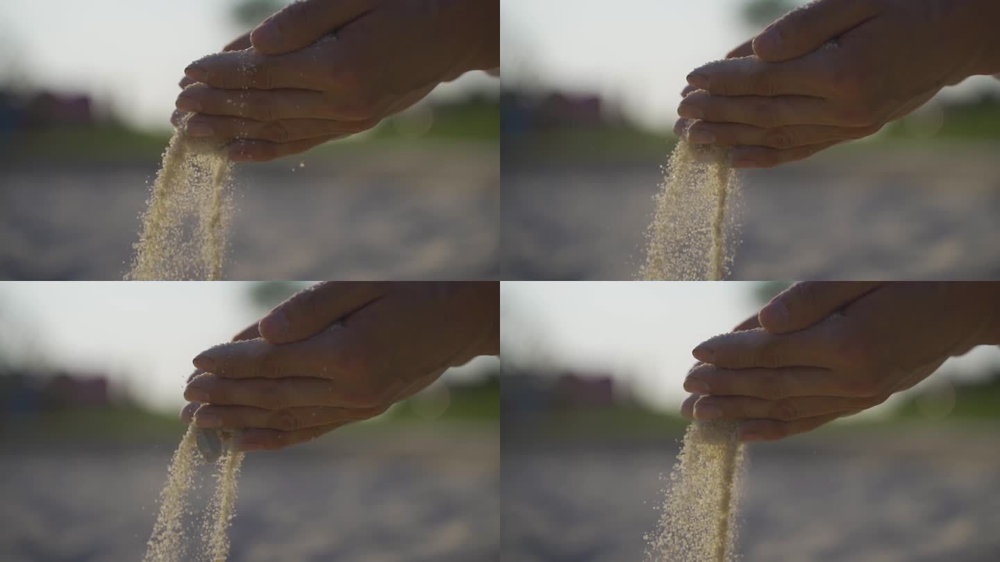 沙粒从手间坠落手捧沙沙子滑落沙滩玩沙