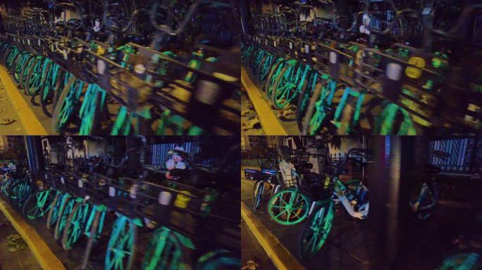 夜晚马路旁边停放的共享单车夜景视频素材