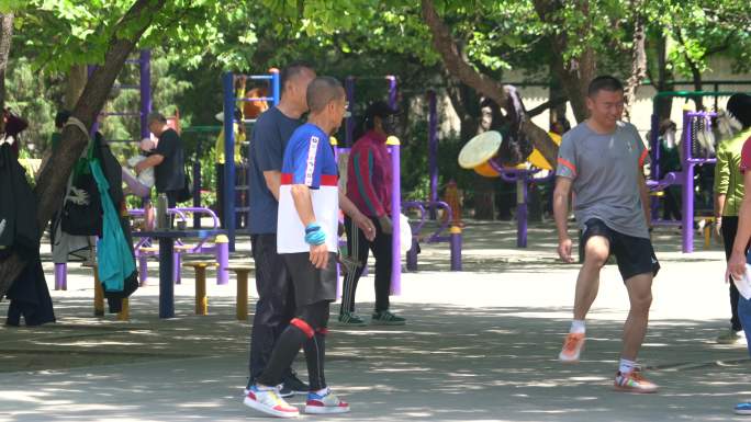 公园里几名男子踢毽子娱乐健身人文实拍