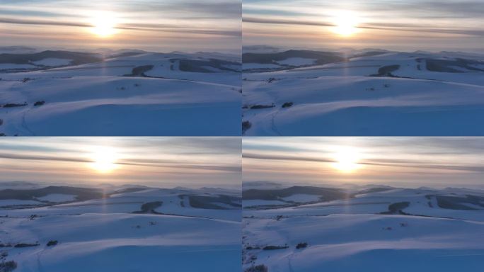航拍冷空气笼罩的苍茫雪原夕照