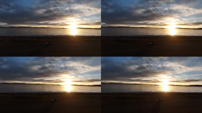停在湖边看日落的汽车越野车