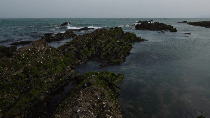 升格拍摄蓝色的海面海浪浪花被风吹散的浪花