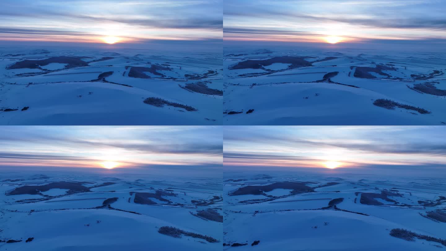 航拍冷空气笼罩的苍茫雪原夕照