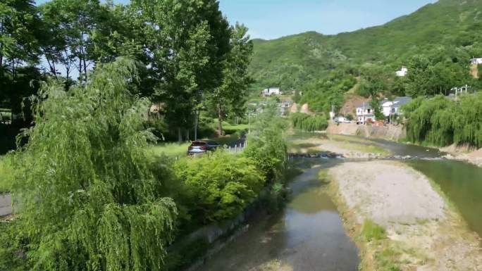 汽车自驾游在乡村景区道路上河边行驶