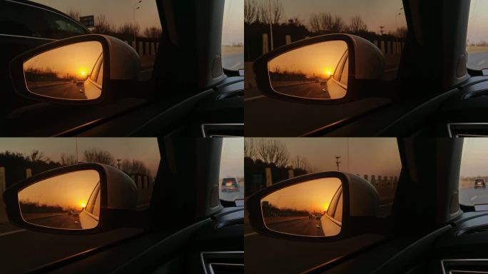 行驶车中后视镜里的夕阳