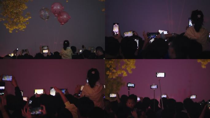 拿手机拍照拍视频繁华市中心夜景人群