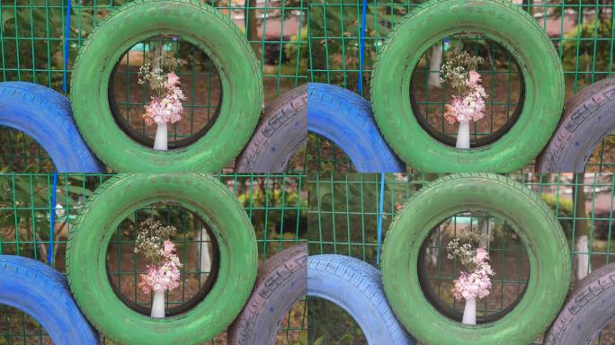 轮胎上的花瓶花鲜花