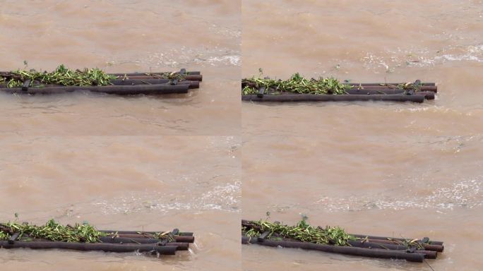 电站泄洪浪花慢镜浮在水上的竹排