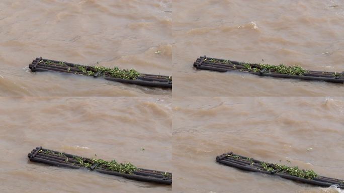 电站泄洪浪花慢镜浮在水上的竹排