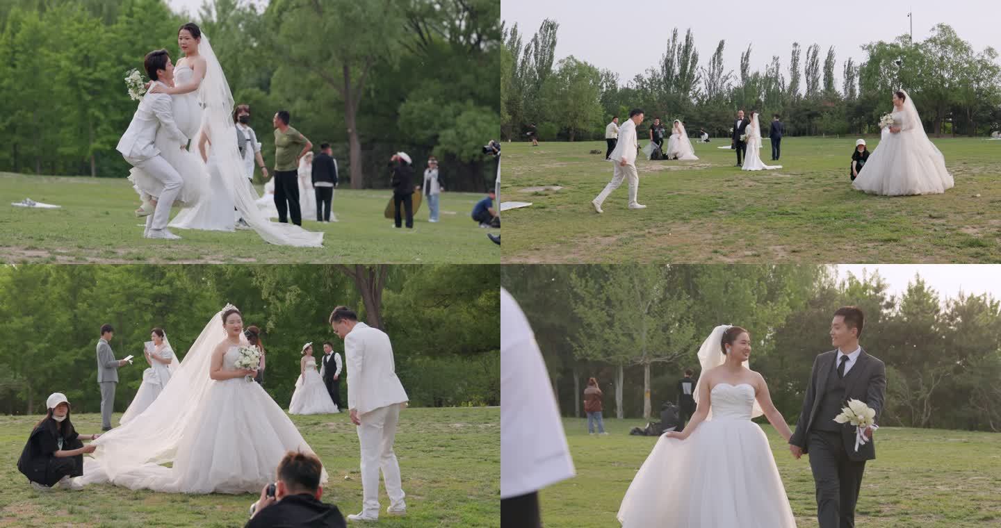 草坪上拍摄婚纱照的新婚情侣们