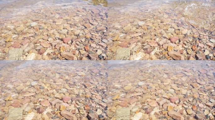 湖水拍打在湖边的石头上