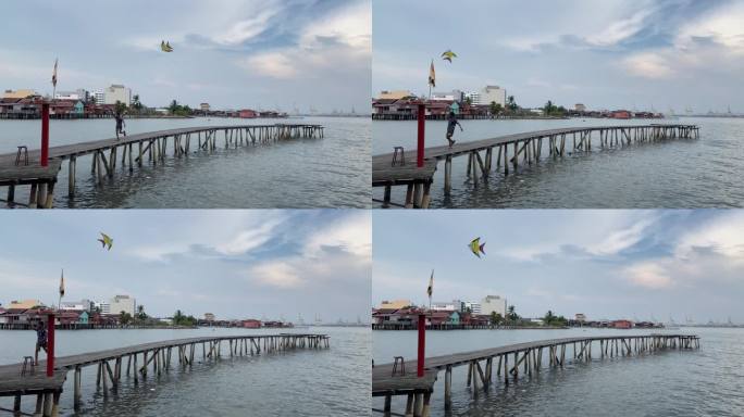 马来西亚槟城姓氏桥码头上放风筝的小孩