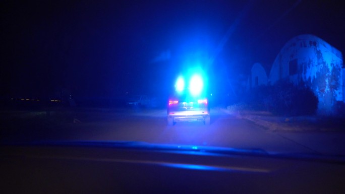 夜晚道路上闪烁的警车警灯