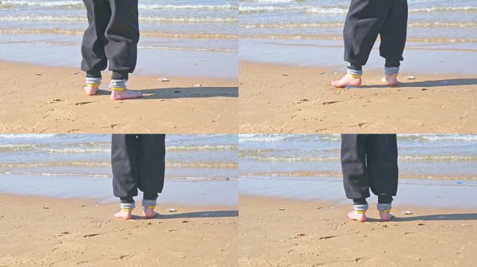 夏天孩子在海边海滩上赤脚奔跑玩耍的慢镜头