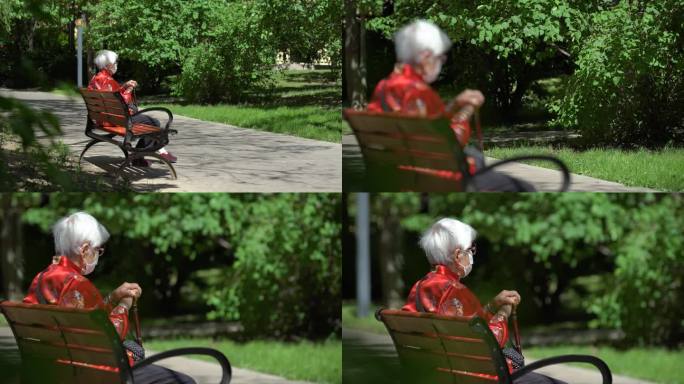 白发老人坐在长椅上晒太阳