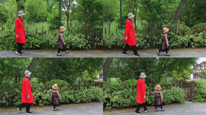 老人带孙女在风车茉莉花墙边散步