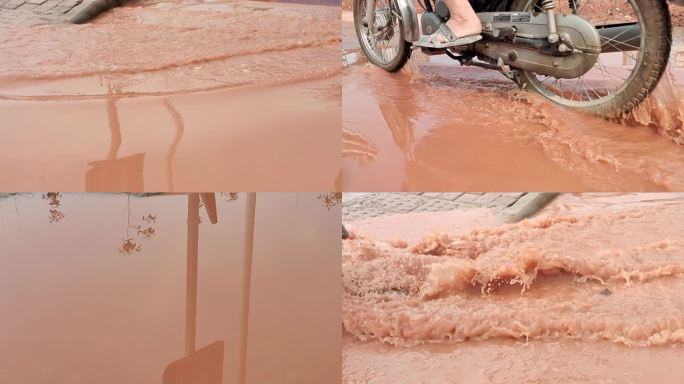 摩托车走过积水路段积水街道暴雨过后 洪水