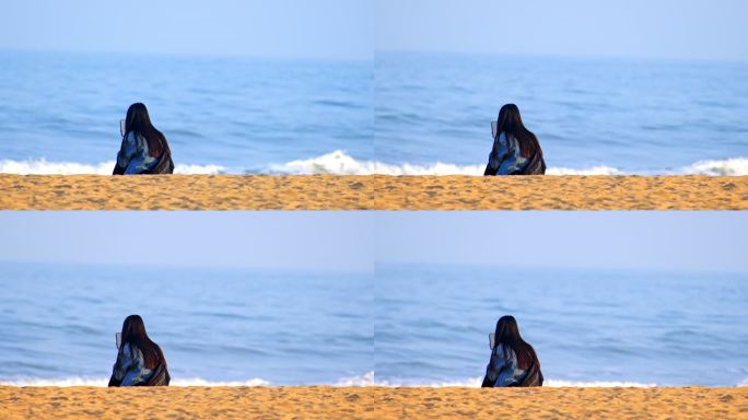 坐在海边玩手机的少女