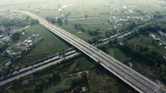 4K航拍在农村穿行而过的城市高速路