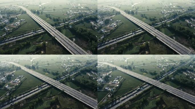 4K航拍在农村穿行而过的城市高速路