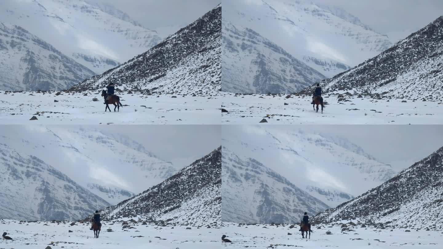 四川阿坝松潘岷山山脉雪中骑马的牧民