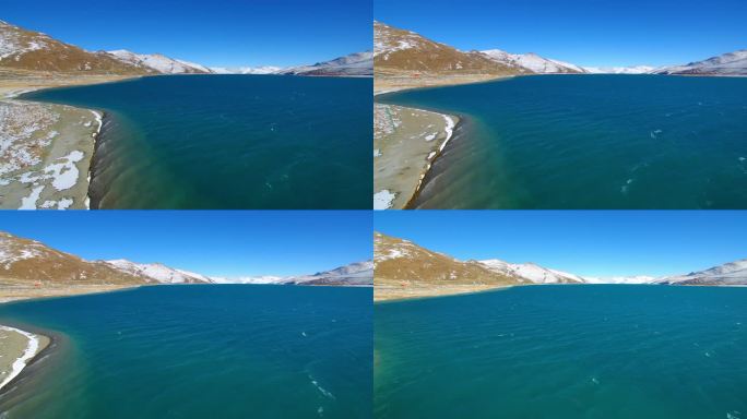 航拍西藏羊湖蓝色湖水与雪山、羊卓雍措