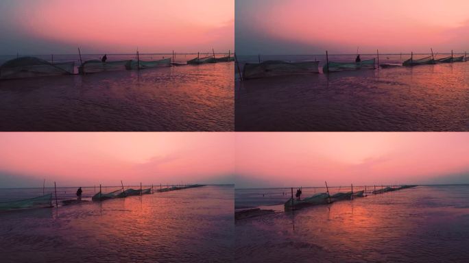 航拍渔民迎着朝阳在黄海边围网捕鱼