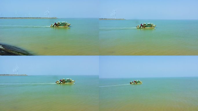 航拍渔民迎着海风驾船在黄海边捕鱼