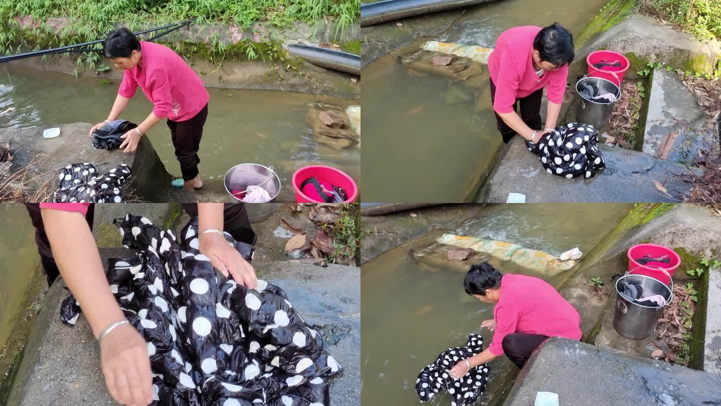 小溪边洗衣服洗衣服的女人手洗衣服视频素材