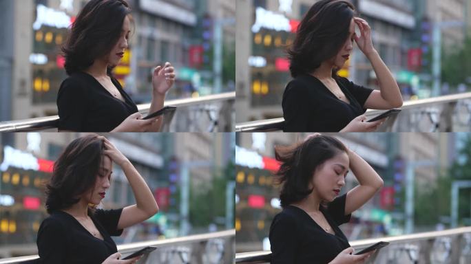 美女商人城市街头使用手机