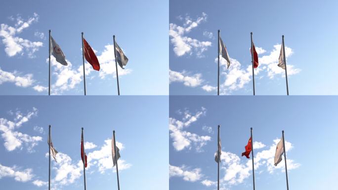 蓝天白云下国旗和亚运会旗帜随风飘舞