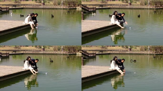 在湖边放飞千纸鹤的年轻情侣